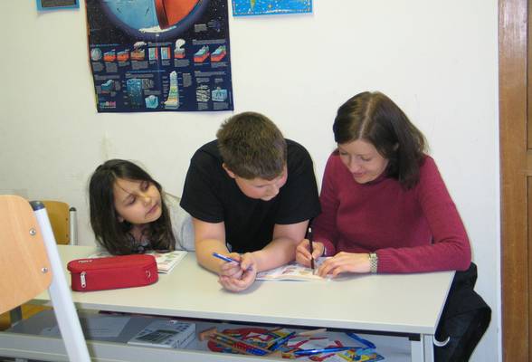 Photo of children engaged in a brain game or puzzle activity, ideally in a classroom or bright playroom setting.